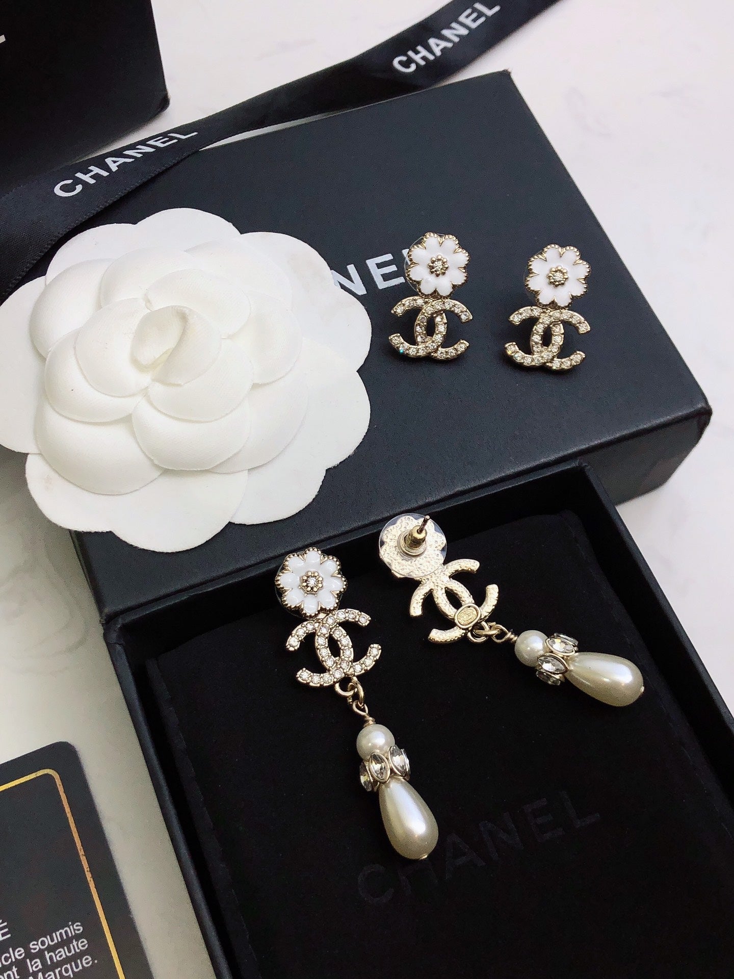 C plower logo and pearl earrings