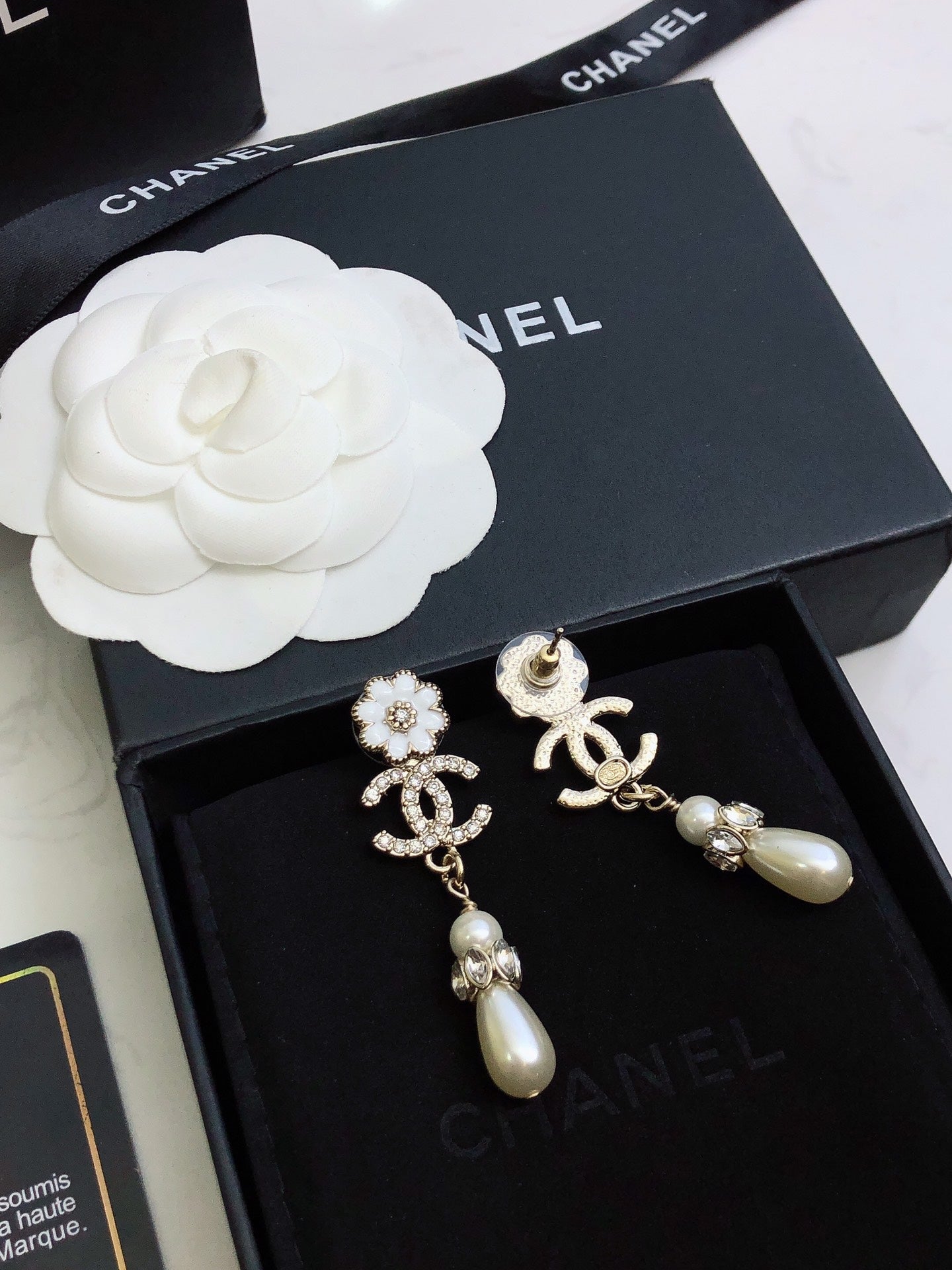C plower logo and pearl earrings