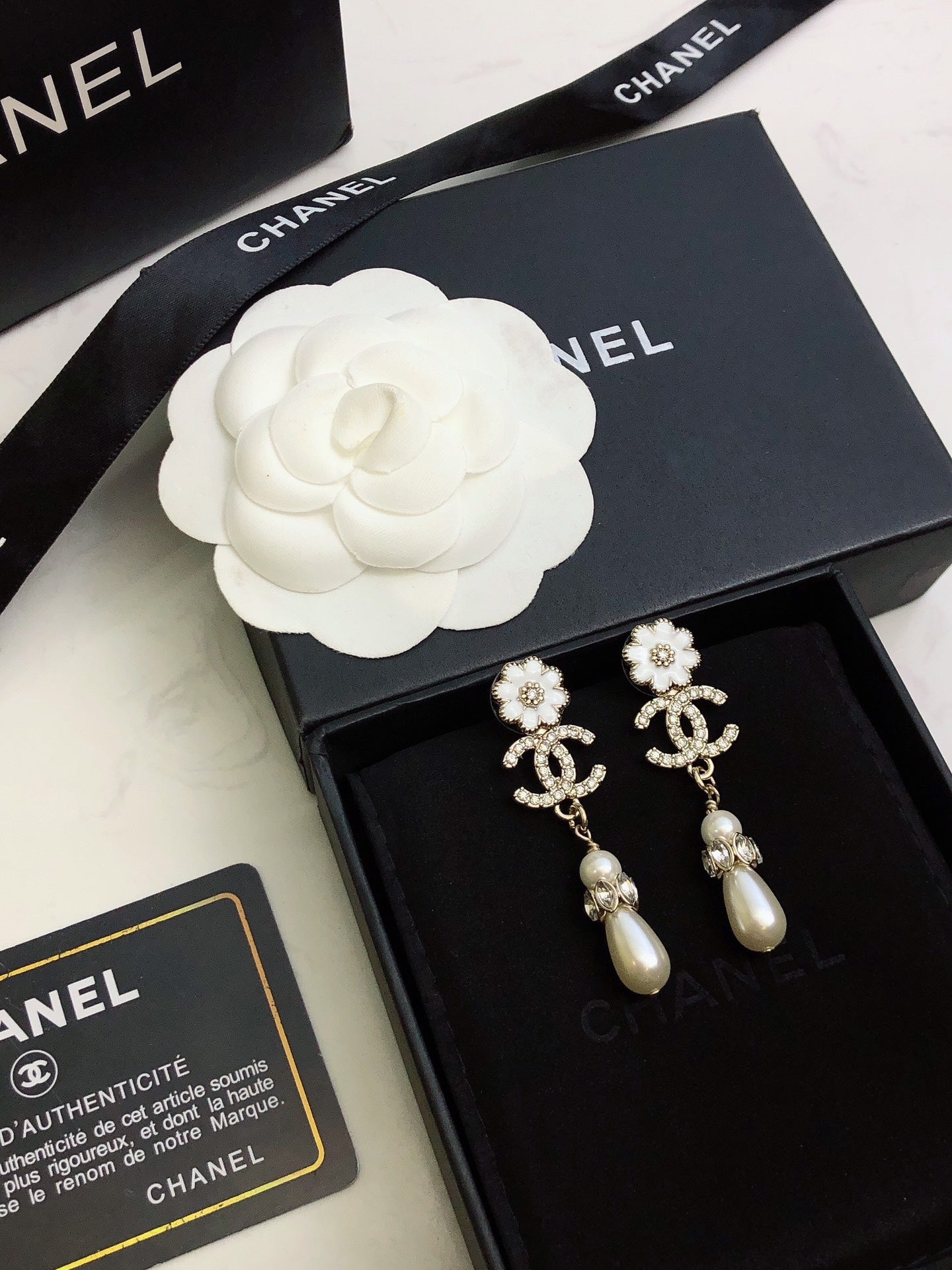 C plower logo and pearl earrings