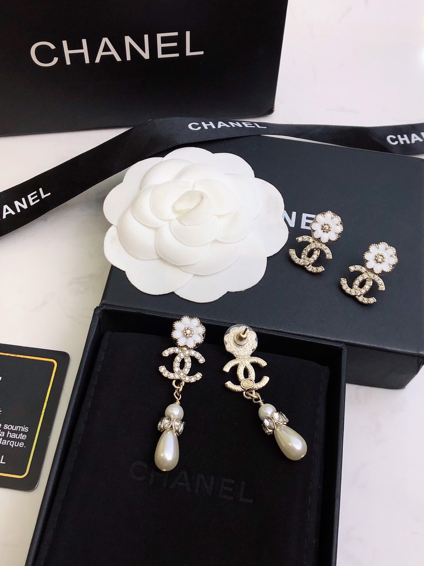C plower logo and pearl earrings
