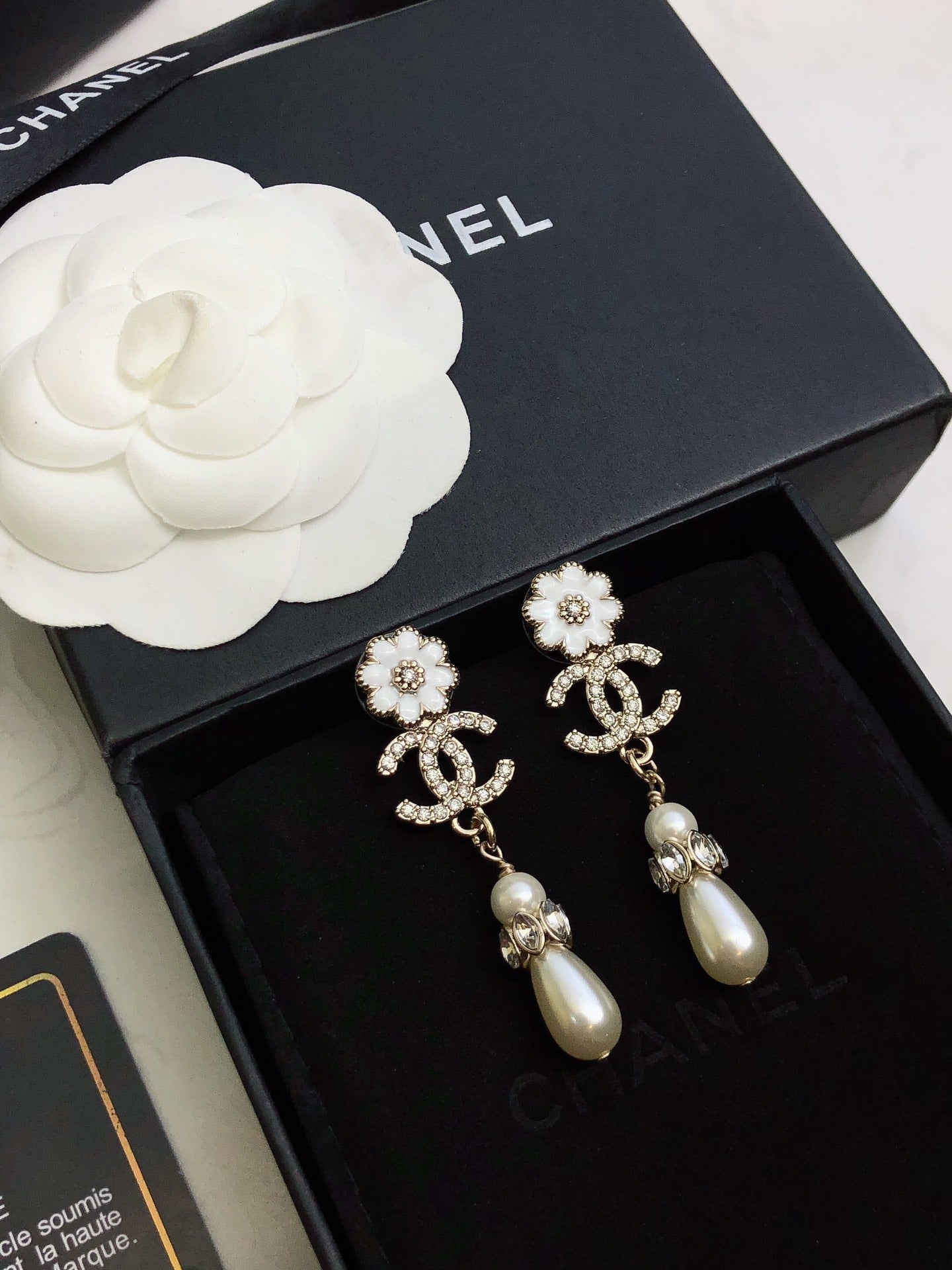 C plower logo and pearl earrings