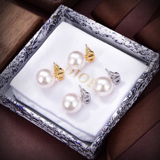 D logo and one pearl earrings