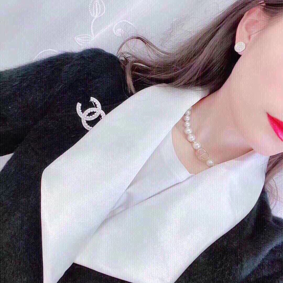 D logo with pearl necklace