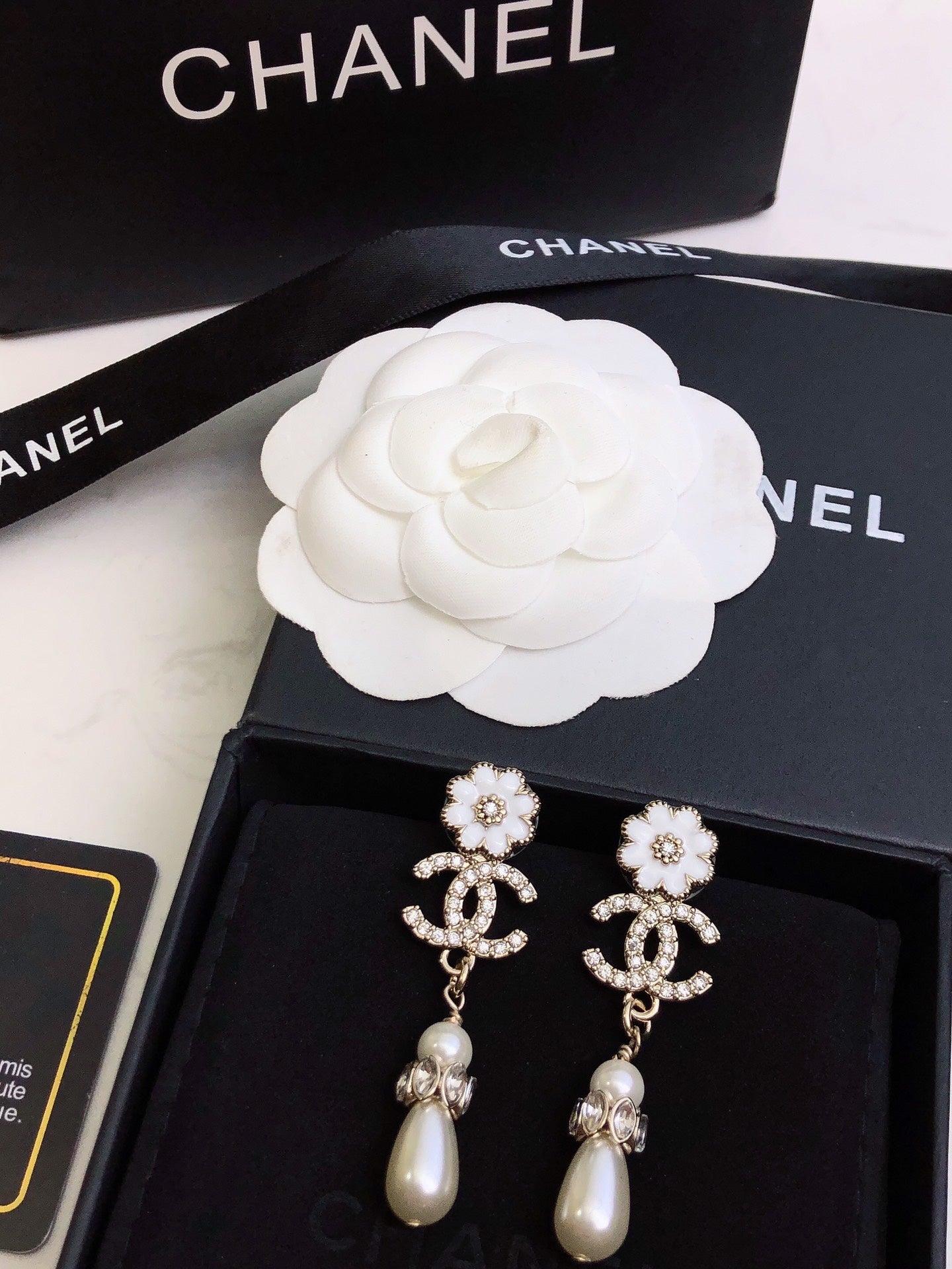 C plower logo and pearl earrings