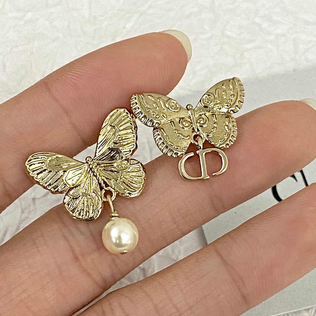 D butterfly logo and pearl earrings